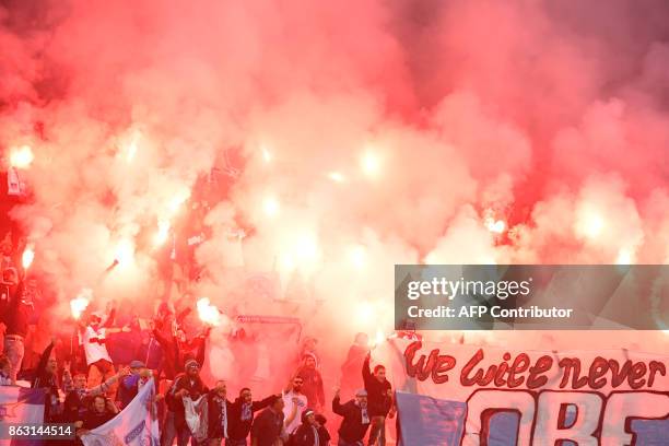Apollon supporters burn flares during the UEFA Europa League group E football match Atalanta vs Apollon Limassol at the Mapei Stadium in Reggio...