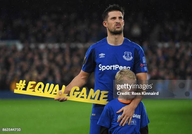 Kevin Mirallas of Everton holds the #equalgame banner prior to the UEFA Europa League Group E match between Everton FC and Olympique Lyon at Goodison...