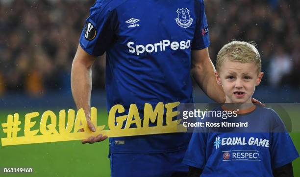 Kevin Mirallas of Everton holds the #equalgame banner alongisde a mascot prior to the UEFA Europa League Group E match between Everton FC and...