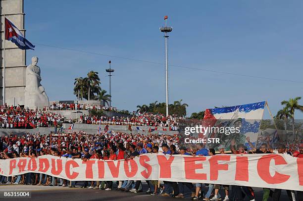 Cubans march at Revolution Square in Havana May 1 during the May Day parade. AFP PHOTO/STR