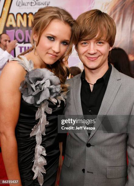 Actress Emily Osment and actor Jason Earles arrive at the premiere of Walt Disney Picture's "Hannah Montana: The Movie" held at the El Captian...