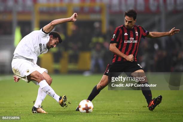 S midfielder Lazaros Christodoulopoulos from Greece fights for the ball with AC Milan's midfielder Giacomo Bonaventura from Italy during the UEFA...