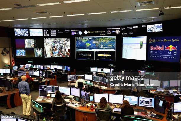 Daniel Ricciardo of Australia and Red Bull Racing and Max Verstappen of Netherlands and Red Bull Racing enjoy a trip to NASA Space Center during...