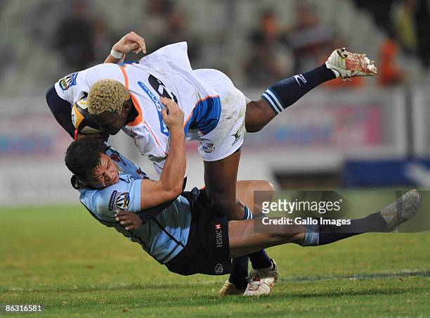 Kabamba Floors of the Cheetahs tackled by Timana Tahu of the Waratahs during the Super 14 match between the Cheetahs and Waratahs at Vodacom Park on...