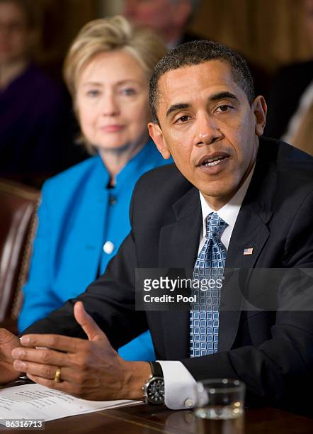 President Barack Obama speaks to his cabinet as Secretary of State Hillary Clinton looks on at the White House on May 1, 2009 in Washington, DC....
