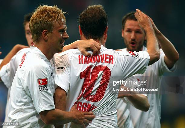 Arnold Bruggink of Hannover celebrates his first goal with Mike Hanke and Christian Schulz during the Bundesliga match between VfL Bochum and...