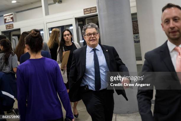 Sen. Al Franken heads to a vote on amendments to the fiscal year 2018 budget resolution, on Capitol Hill, October 19, 2017 in Washington, DC....