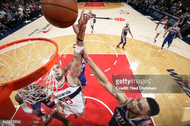 Marcin Gortat of the Washington Wizards drives to the basket against the Philadelphia 76ers on October 18, 2017 at Capital One Arena in Washington,...