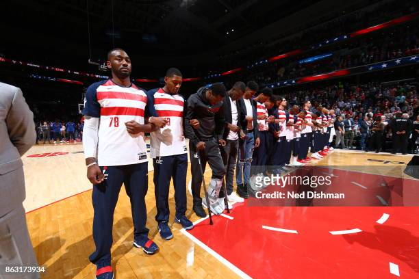 The Washington Wizards during the national anthem before the game against the Philadelphia 76ers on October 18, 2017 at Capital One Arena in...