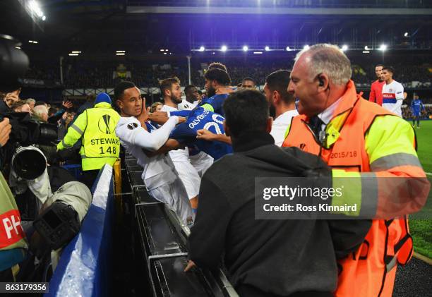 Players clash and fans are restrained after a challenge by Ashley Williams of Everton on Anthony Lopes of Lyon during the UEFA Europa League Group E...