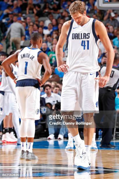 Dennis Smith Jr. #1 and Dirk Nowitzki of the Dallas Mavericks walk up the court during the game against the Atlanta Hawks at the American Airlines...