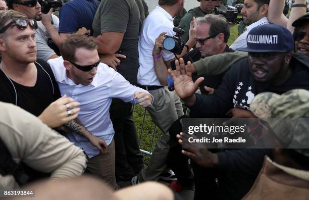 Supporters of white nationalist Richard Spencer, who popularized the term "alt-right" clash with people protesting against him after his speech at...