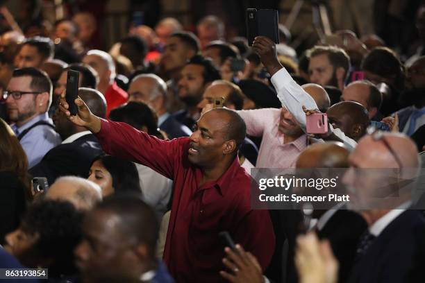 People cheer and take pictures as Former U.S. President Barack Obama speaks at a rally in support of Democratic candidate Phil Murphy, who is running...