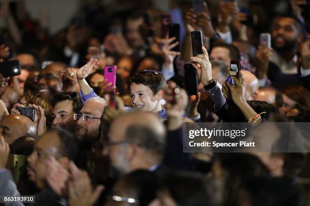 People cheer and take pictures as Former U.S. President Barack Obama speaks at a rally in support of Democratic candidate Phil Murphy, who is running...