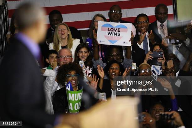 People cheer and take pictures as Former U.S. President Barack Obama speaks at a rally in support of Democratic candidate Phil Murphy, who is running...