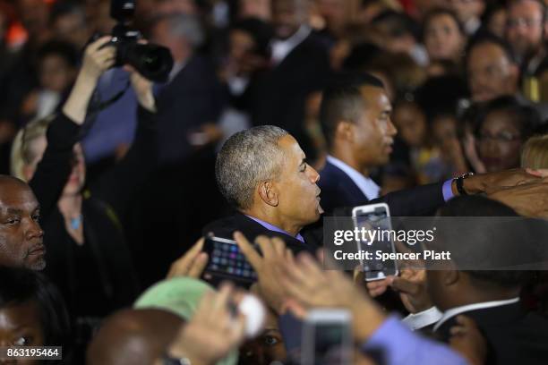 Former U.S. President Barack Obama shakes hands after speaking at a rally in support of Democratic candidate Phil Murphy, who is running against...