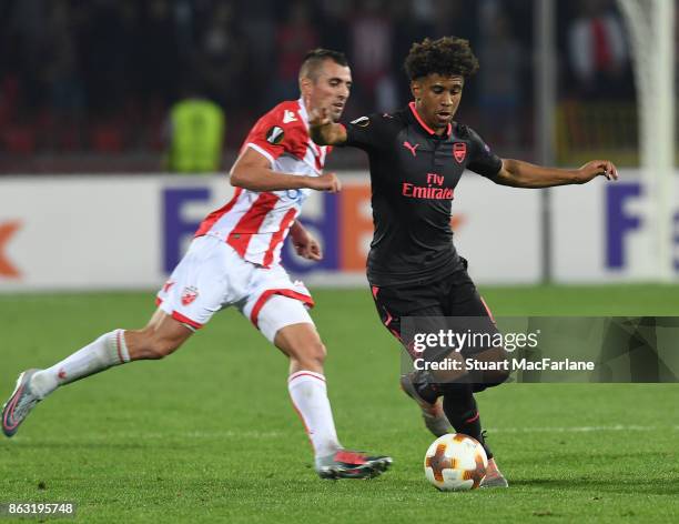 Reiss Nelson of Arsenal breaks past Nenad Krsticic of Red Star during the UEFA Europa League group H match between Crvena Zvezda and Arsenal FC at...