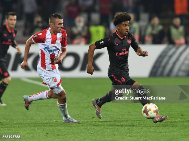 Reiss Nelson of Arsenal breaks past Nenad Krsticic of Red Star during the UEFA Europa League group H match between Crvena Zvezda and Arsenal FC at...