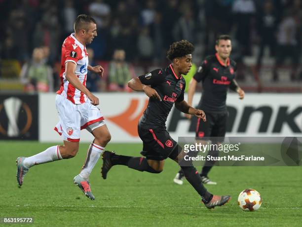 Reiss Nelson of Arsenal breaks past Nenad Krsticic of Red Star during the UEFA Europa League group H match between Crvena Zvezda and Arsenal FC at...
