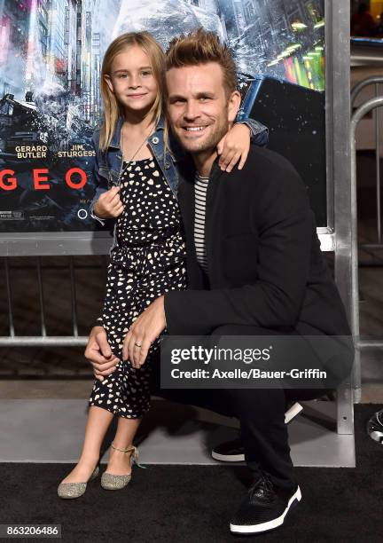 Actor John Brotherton and daughter arrive at the premiere of 'Geostorm' at TCL Chinese Theatre on October 16, 2017 in Hollywood, California.