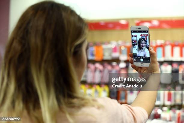 Woman takes a selfie with an Apple phone after Apple launched iPhone 8 and iPhone 8 plus at Vodafone store in Ankara, Turkey on October 19, 2017.