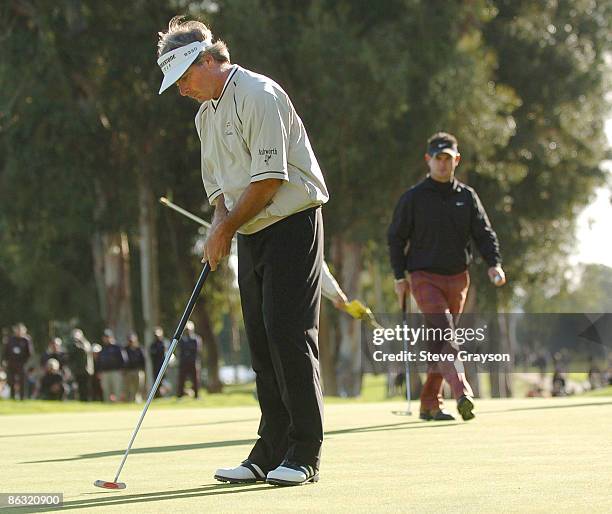 Fred Couples taps in for par as Rory Sabbatini approaches for his final putt during the final round of the 2006 Nissan Open Presented by Nissan at...