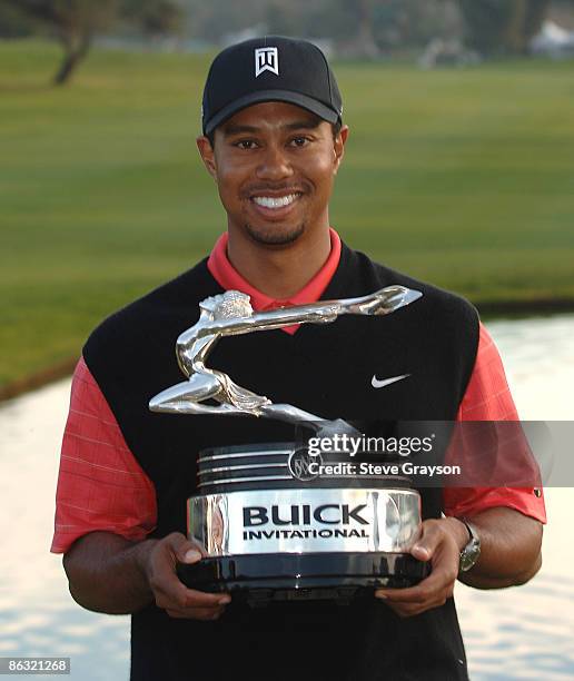 Tiger Woods holds the winner's trophy after defeating Jose Maria Olazabal and Nathan Green in a playoff during the final round of the PGA TOUR's 2006...