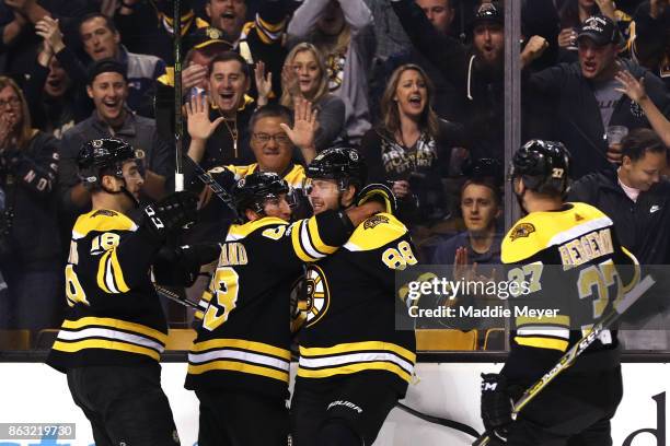 David Pastrnak of the Boston Bruins celebrates with Kenny Agostino, Brad Marchand and Patrice Bergeron after scoring a goal against the Vancouver...