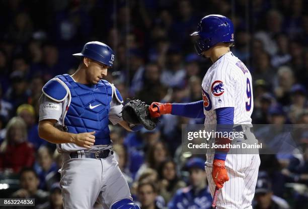 Austin Barnes of the Los Angeles Dodgers tags out Javier Baez of the Chicago Cubs after a dropped third strike in the second inning during game five...