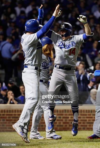 Cody Bellinger and Enrique Hernandez of the Los Angeles Dodgers celebrate after Hernandez hit a grand slam in the third inning against the Chicago...