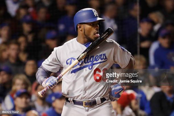 Yasiel Puig of the Los Angeles Dodgers licks his bat while batting in the third inning against the Chicago Cubs during game five of the National...