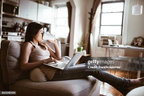 woman looking the tv at home and working - breakfast tv stock pictures, royalty-free photos & images