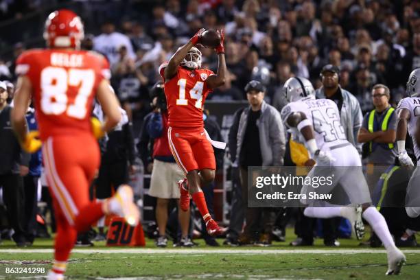 Demarcus Robinson of the Kansas City Chiefs makes a 33-yard catch against the Oakland Raiders during their NFL game at Oakland-Alameda County...