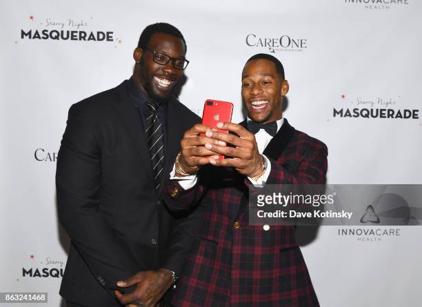 Players Jason Pierre Paul and Victor Cruz attend Daniel E Straus & CareOne Starry Night Masquerade For Puerto Ricoat Skylight Clarkson North on...