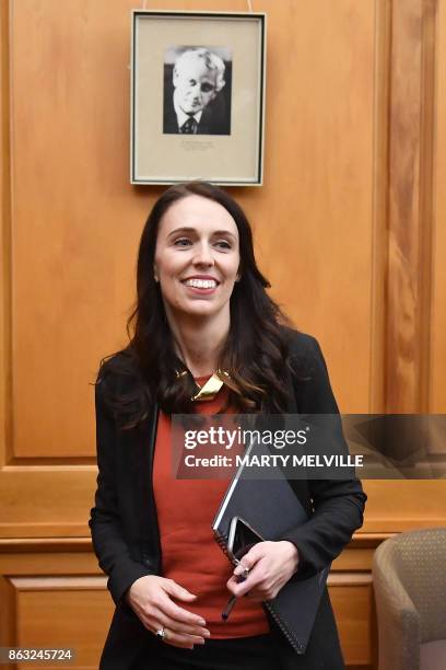 New Zealand's Labour party leader Jacinda Ardern receives applause as she is welcomed to her first caucus meeting as Prime Minister-elect at...