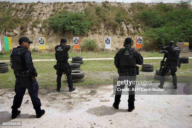 In this photo taken on August 24 Thai police from the Narcotics Suppression Bureau Division 3 undergo firearms training at a camp in Hua Hin,...