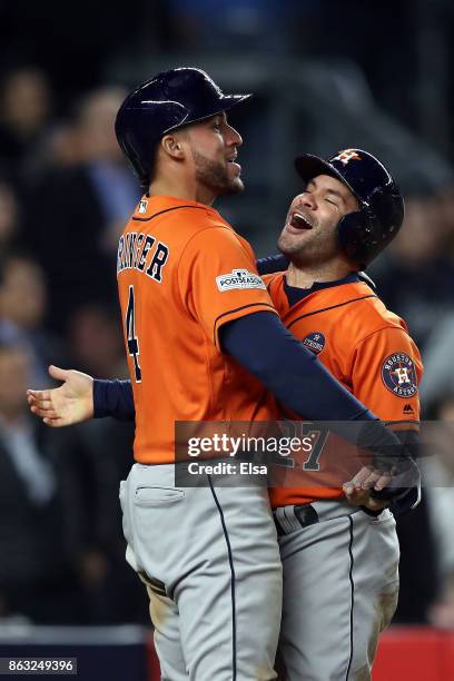 Jose Altuve and George Springer of the Houston Astros celebrate after scoring on a Yuli Gurriel 3-run double during the sixth inning against the New...