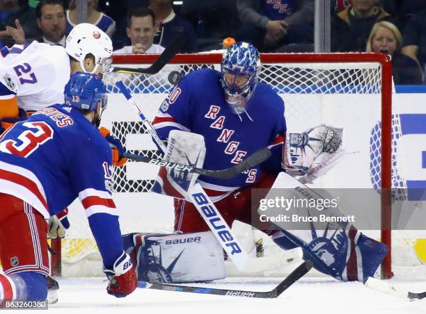 Shot by Mathew Barzal of the New York Islanders hits the shoulder of Henrik Lundqvist of the New York Rangers during the third period at Madison...