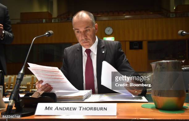 Andrew Thorburn, chief executive officer of National Australia Bank Ltd. , reads documents ahead of a hearing before the House of Representatives...