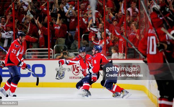 Alex Ovechkin and Sergei Fedorov of the Washington Capitals celebrate Fedorov's game winning goal against the New York Rangers during Game Seven of...