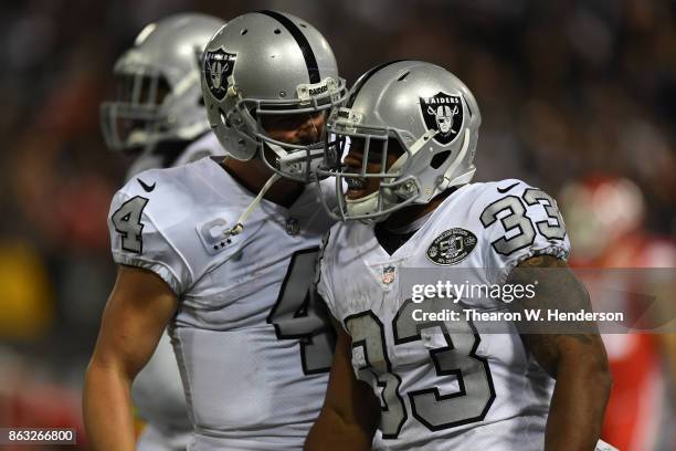 Derek Carr and DeAndre Washington of the Oakland Raiders celebrate after a touchdown against the Kansas City Chiefs during their NFL game at...