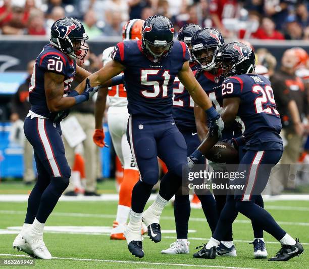 Will Fuller of the Houston Texans comes up hobbling after intercepting a pass as Marcus Burley and Andre Hal assist himat NRG Stadium on October 15,...