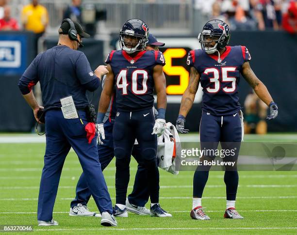 Head coach Bill O'Brien of the Houston Texans gives instructions to Marcus Williams and Eddie Pleasant at NRG Stadium on October 15, 2017 in Houston,...