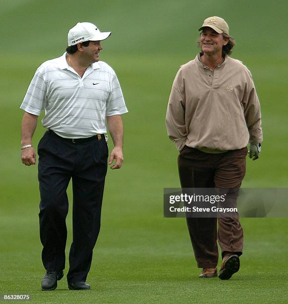 Mike Eruzione and Kurt Russell walk up the 10th fairway during round one of the 46th Bob Hope Chrysler Classic Celebirty Pro-Am at Bermuda Dunes...