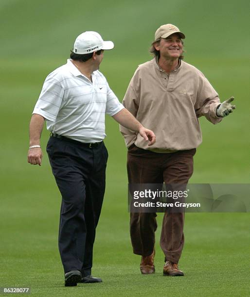 Mike Eruzione and Kurt Russell walk up the 10th fairway during round one of the 46th Bob Hope Chrysler Classic Celebirty Pro-Am at Bermuda Dunes...