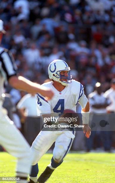 Jim Harbaugh of the Indianapolis Colts looks to pass against the Oakland Raiders at Oakland Stadium circa 1995 in Oakland, California.