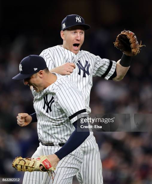 Todd Frazier and Greg Bird of the New York Yankees celebrate after defeating the Houston Astros by a score of 6-4 to win Game Four of the American...