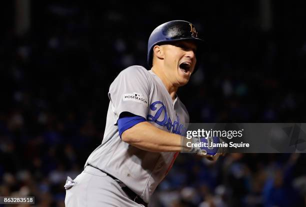 Enrique Hernandez of the Los Angeles Dodgers celebrates after hitting a two-run home run in the ninth inning against the Chicago Cubs during game...