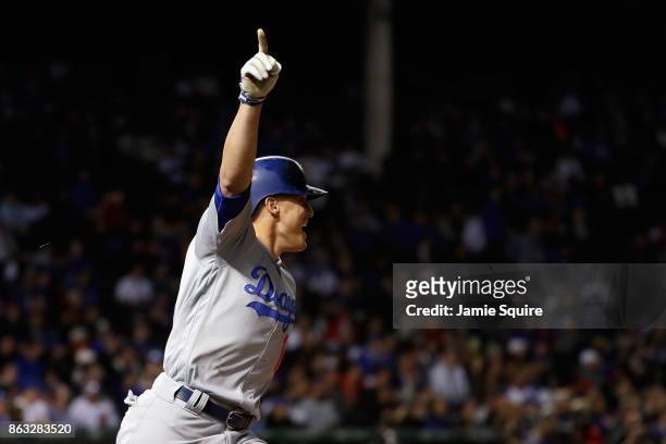 Enrique Hernandez of the Los Angeles Dodgers celebrates after hitting a two-run home run in the ninth inning against the Chicago Cubs during game...