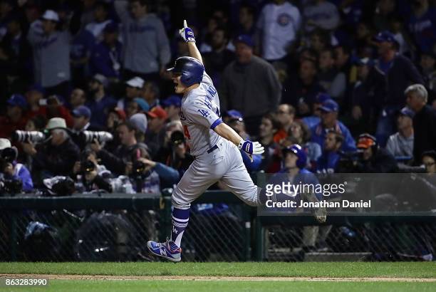 Enrique Hernandez of the Los Angeles Dodgers celebrates after hitting a two-run home run in the ninth inning against the Chicago Cubs during game...